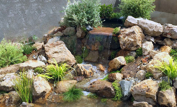 a stylish waterfall and pond designed by our dedicated team